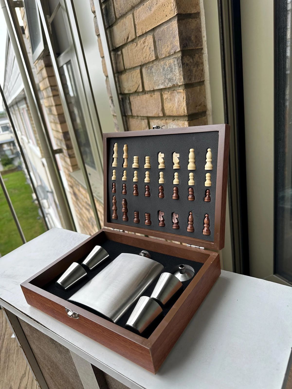 Open chess set silver drinks accessories.