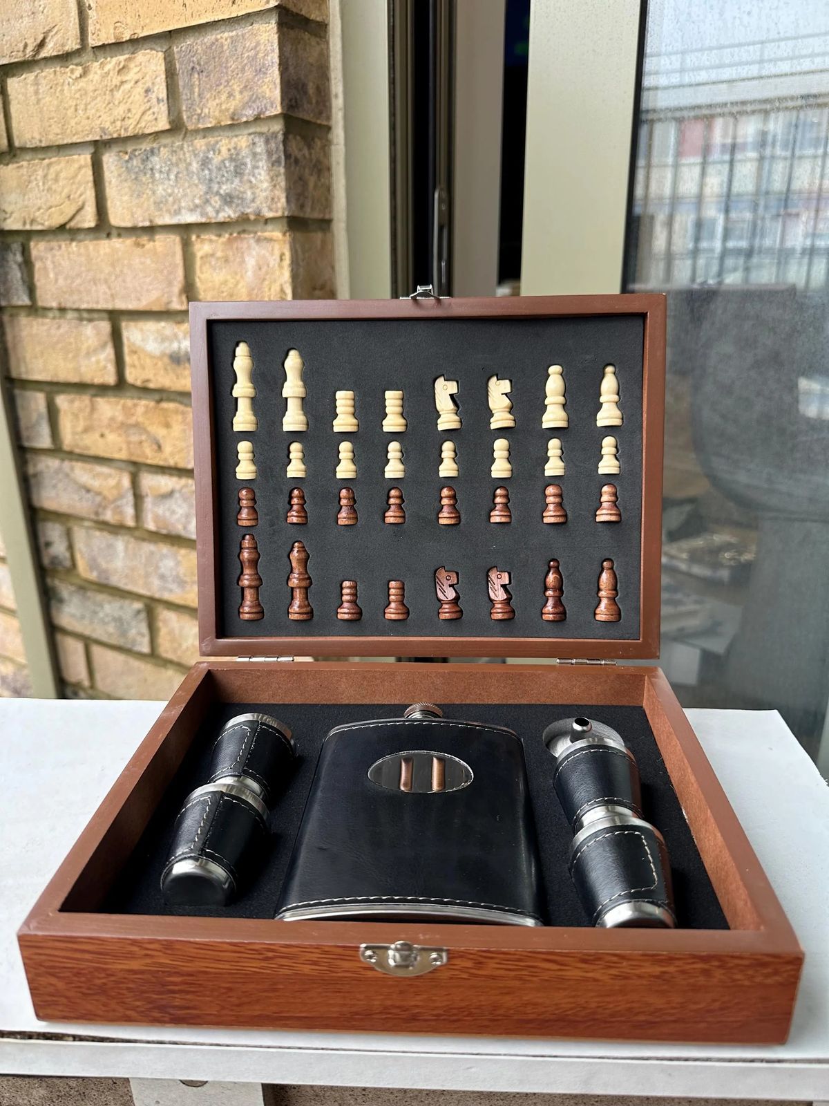 Open wooden chess set flask cups.