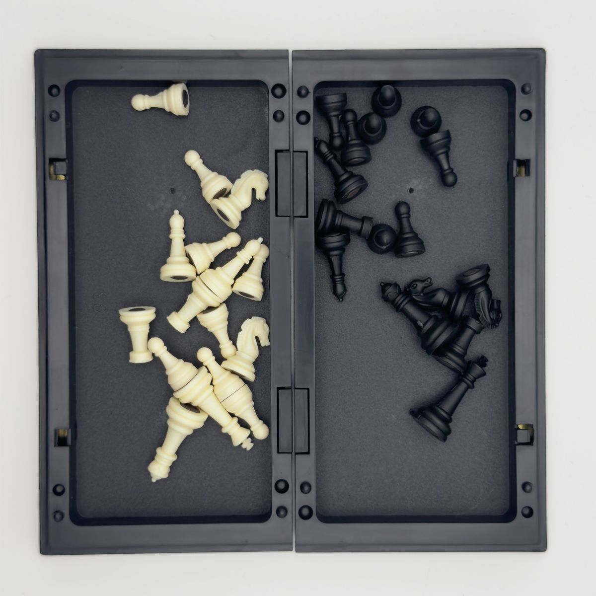 Folding chess set piece storage.